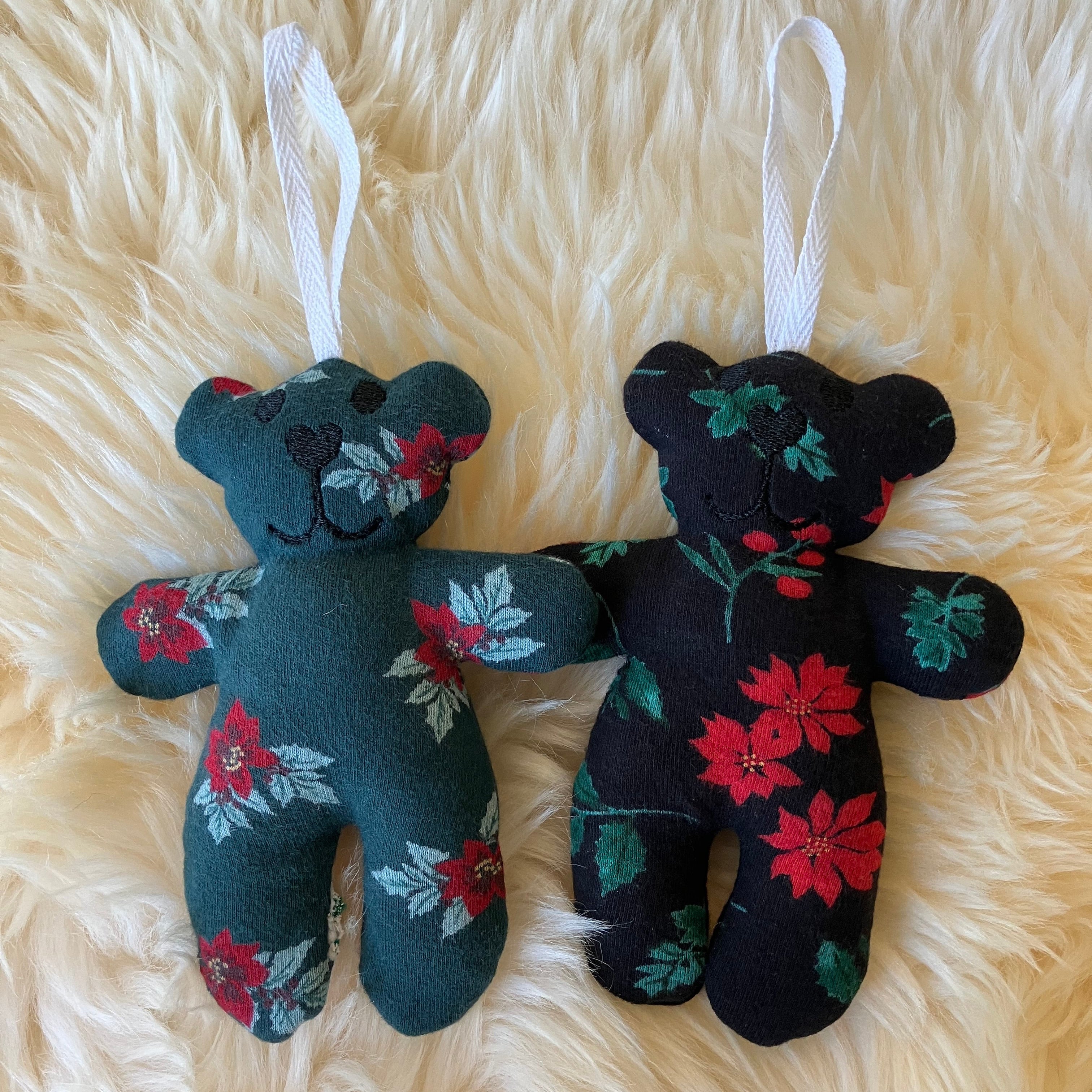 Two plush toys with floral patterns on a fluffy beige surface